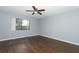 Bedroom with wood-look floors and a large window at 748 N Gretna Ct, Winter Springs, FL 32708