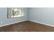 Spacious bedroom with wood-look floors and large window at 748 N Gretna Ct, Winter Springs, FL 32708