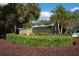 The Highlands community entrance, featuring a landscaped entryway with lush greenery and palm trees at 748 N Gretna Ct, Winter Springs, FL 32708