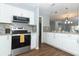 Modern kitchen featuring white cabinets, stainless steel appliances, and granite countertops at 748 N Gretna Ct, Winter Springs, FL 32708