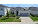 This single-story house features a gray exterior and a two-car garage at 764 Sarner Pass Way, Winter Haven, FL 33881