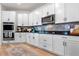 Modern kitchen with stainless steel appliances and white cabinets at 764 Sarner Pass Way, Winter Haven, FL 33881