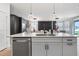 Kitchen island with quartz countertop and stainless steel dishwasher at 764 Sarner Pass Way, Winter Haven, FL 33881