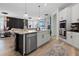 Kitchen island with quartz countertop and stainless steel dishwasher at 764 Sarner Pass Way, Winter Haven, FL 33881