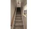 Carpeted staircase with wood railing at 820 W 25Th St, Sanford, FL 32771