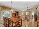 Spacious dining area, wood table and chairs, view into living room at 900 Khingan Ct, Apopka, FL 32712