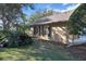 House exterior with tan siding and dark shutters at 900 Khingan Ct, Apopka, FL 32712