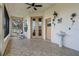 Covered porch with tiled floor, French doors, and outdoor sink at 111 Millholland St, Oakland, FL 34760