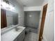 Bathroom with grey tiled walls and bathtub at 113 W 1St St, Debary, FL 32713