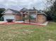 Brick house with a two-car garage and landscaped front yard at 113 W 1St St, Debary, FL 32713