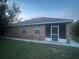 Brick house with screened porch and well-maintained lawn at 113 W 1St St, Debary, FL 32713