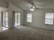 Spacious living room with carpet flooring and sliding glass doors at 113 W 1St St, Debary, FL 32713