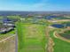 An expansive aerial view of the community golf driving range with multiple target greens at 1312 Shinnecock Hills Dr, Davenport, FL 33896