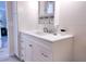 Bathroom with white vanity, updated fixtures, and linen storage at 1401 W Highway 50 # 138, Clermont, FL 34711