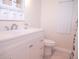 Clean bathroom featuring a white vanity, toilet, and updated fixtures at 1401 W Highway 50 # 138, Clermont, FL 34711
