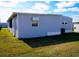 Rear view of gray mobile home showcasing clean siding at 1401 W Highway 50 # 138, Clermont, FL 34711