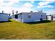 Gray mobile home with screened porch and grassy yard at 1401 W Highway 50 # 138, Clermont, FL 34711