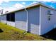 Side view of gray manufactured home with grassy yard at 1401 W Highway 50 # 138, Clermont, FL 34711