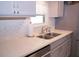 Modern kitchen with double sink, gray cabinets and quartz countertops at 1401 W Highway 50 # 138, Clermont, FL 34711