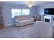 Living room with a sofa, recliner, and a decorative fireplace at 1401 W Highway 50 # 138, Clermont, FL 34711