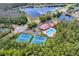 Aerial view of community pool, tennis courts, and lake at 14783 Yorkshire Run Dr, Orlando, FL 32828