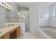 Bathroom features double vanity, shower, and a jetted tub at 14783 Yorkshire Run Dr, Orlando, FL 32828