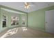 Well-lit bedroom featuring a bay window and ceiling fan at 14783 Yorkshire Run Dr, Orlando, FL 32828
