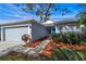 Single-story house with attached garage, landscaping, and walkway at 14783 Yorkshire Run Dr, Orlando, FL 32828