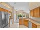 Kitchen features wood cabinets, stainless steel appliances, and tile floor at 14783 Yorkshire Run Dr, Orlando, FL 32828