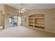 Living room with vaulted ceiling, built-in shelving, and backyard access at 14783 Yorkshire Run Dr, Orlando, FL 32828