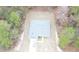 Aerial view of a house showcasing the roof, surrounding trees, and car at 15322 Sw 50Th Court Rd, Ocala, FL 34473