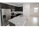 Modern kitchen featuring granite countertops, stainless steel appliances, and dark cabinetry at 15322 Sw 50Th Court Rd, Ocala, FL 34473