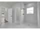 Modern bathroom featuring a tiled walk-in shower, bright natural light, and neutral tones at 15568 Sw 46Th Cir, Ocala, FL 34473