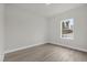 Bedroom with a window, light-colored walls, and modern baseboards at 15568 Sw 46Th Cir, Ocala, FL 34473