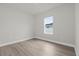 Simple bedroom featuring wood-look flooring and a window at 15568 Sw 46Th Cir, Ocala, FL 34473