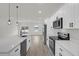 Bright kitchen features white cabinets, stainless appliances, stone countertops, and a center island at 15568 Sw 46Th Cir, Ocala, FL 34473