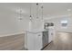 Bright kitchen with stainless steel appliances, white cabinetry, and modern island at 15568 Sw 46Th Cir, Ocala, FL 34473
