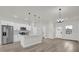 Well-lit, modern kitchen with stainless steel appliances, sleek white cabinetry, and a convenient island at 15568 Sw 46Th Cir, Ocala, FL 34473