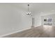 Open-concept living room boasts modern light fixture and sliding glass doors to the backyard at 15568 Sw 46Th Cir, Ocala, FL 34473