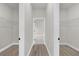 Hallway with dual walk-in closets featuring wire shelving for optimal storage at 15568 Sw 46Th Cir, Ocala, FL 34473