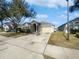 House exterior view from the street, with a driveway at 161 Pinefield Dr, Sanford, FL 32771