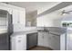 Modern kitchen with white cabinets, granite countertops, and stainless steel appliances at 161 Pinefield Dr, Sanford, FL 32771
