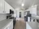 Modern kitchen with white cabinets and stainless steel appliances at 161 Pinefield Dr, Sanford, FL 32771