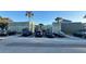 Exterior view of a condo building with parking lot and tropical landscaping at 198 Scottsdale Sq # 198, Winter Park, FL 32792