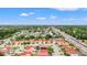 An aerial neighborhood view with well-manicured lawns and beautiful landscaping and terracotta tile roofs at 2317 Santa Lucia St, Kissimmee, FL 34743