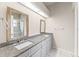 Bathroom featuring double sinks, granite counters, and large mirrors at 2317 Santa Lucia St, Kissimmee, FL 34743