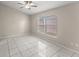 Bedroom featuring tile floors, a ceiling fan, and a large window at 2317 Santa Lucia St, Kissimmee, FL 34743