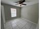 Bedroom with window, ceiling fan and tile floors at 2317 Santa Lucia St, Kissimmee, FL 34743