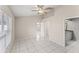 Spacious bedroom with tile floors, a ceiling fan, and an ensuite bathroom at 2317 Santa Lucia St, Kissimmee, FL 34743