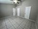 Large bedroom with tile floors and two entry doors at 2317 Santa Lucia St, Kissimmee, FL 34743